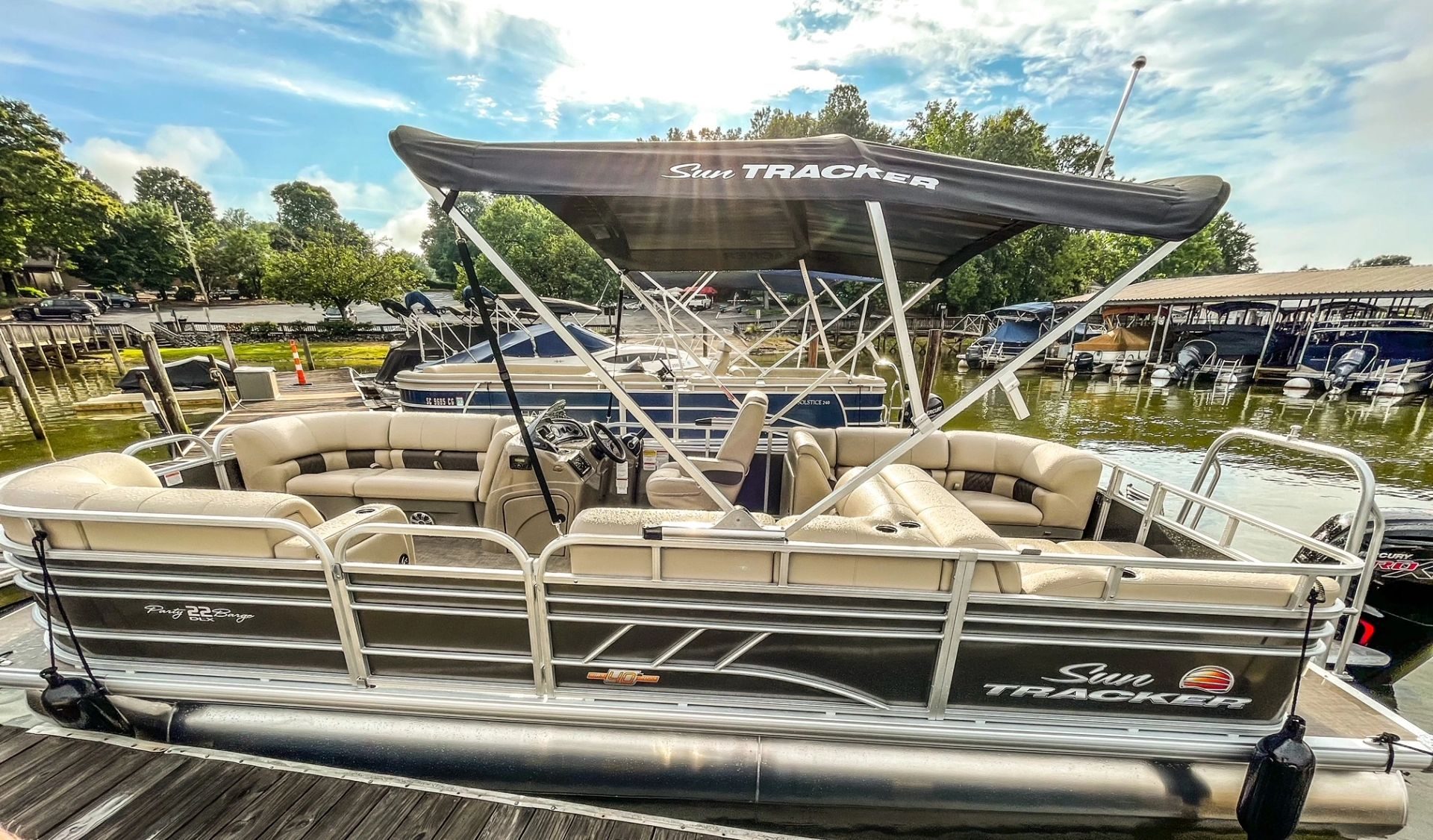 Inside the pontoon at the dock, seating and bimini shade ready for guests