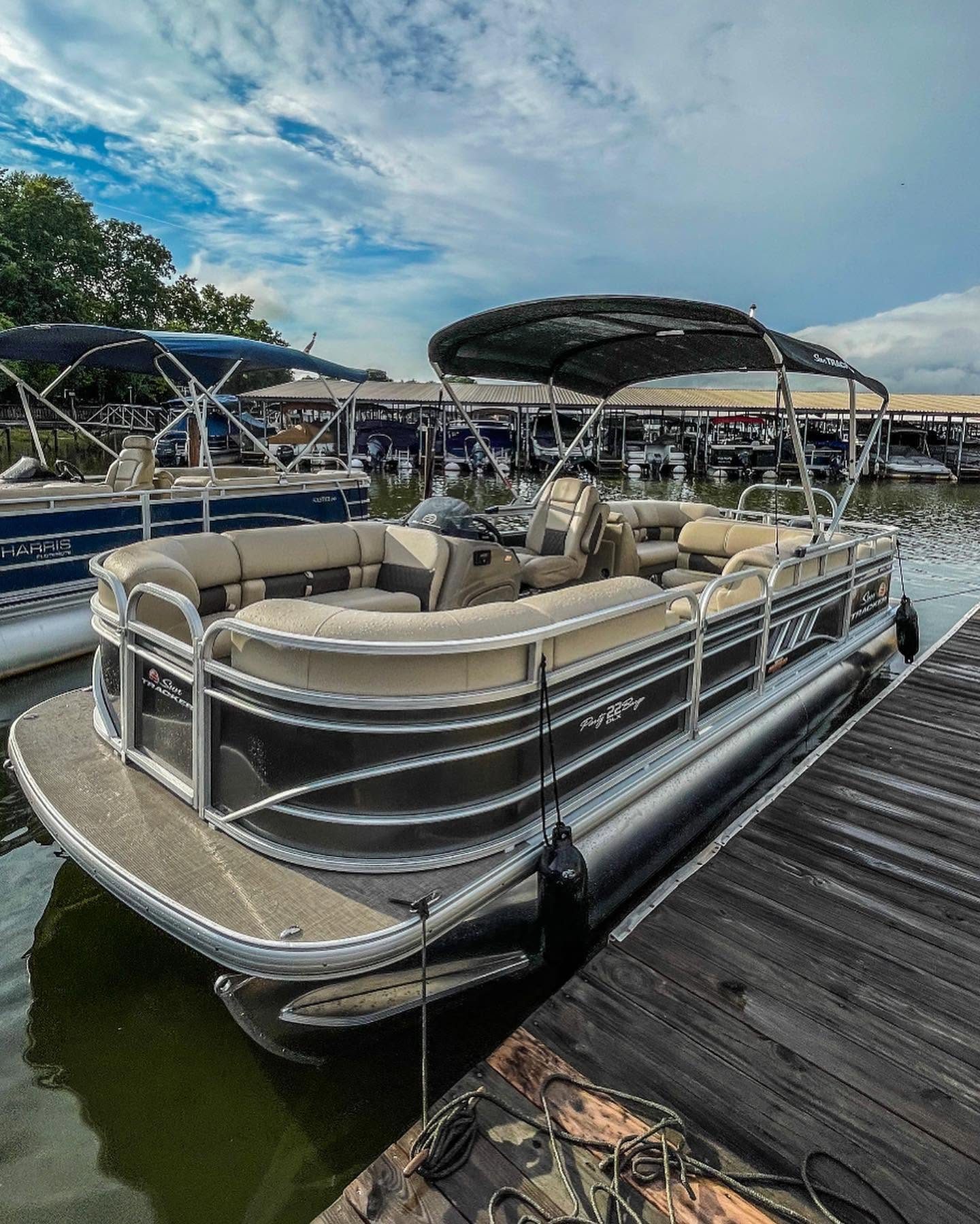 The 2023 Sun Tracker Party Barge 22 DLX pontoon at the dock