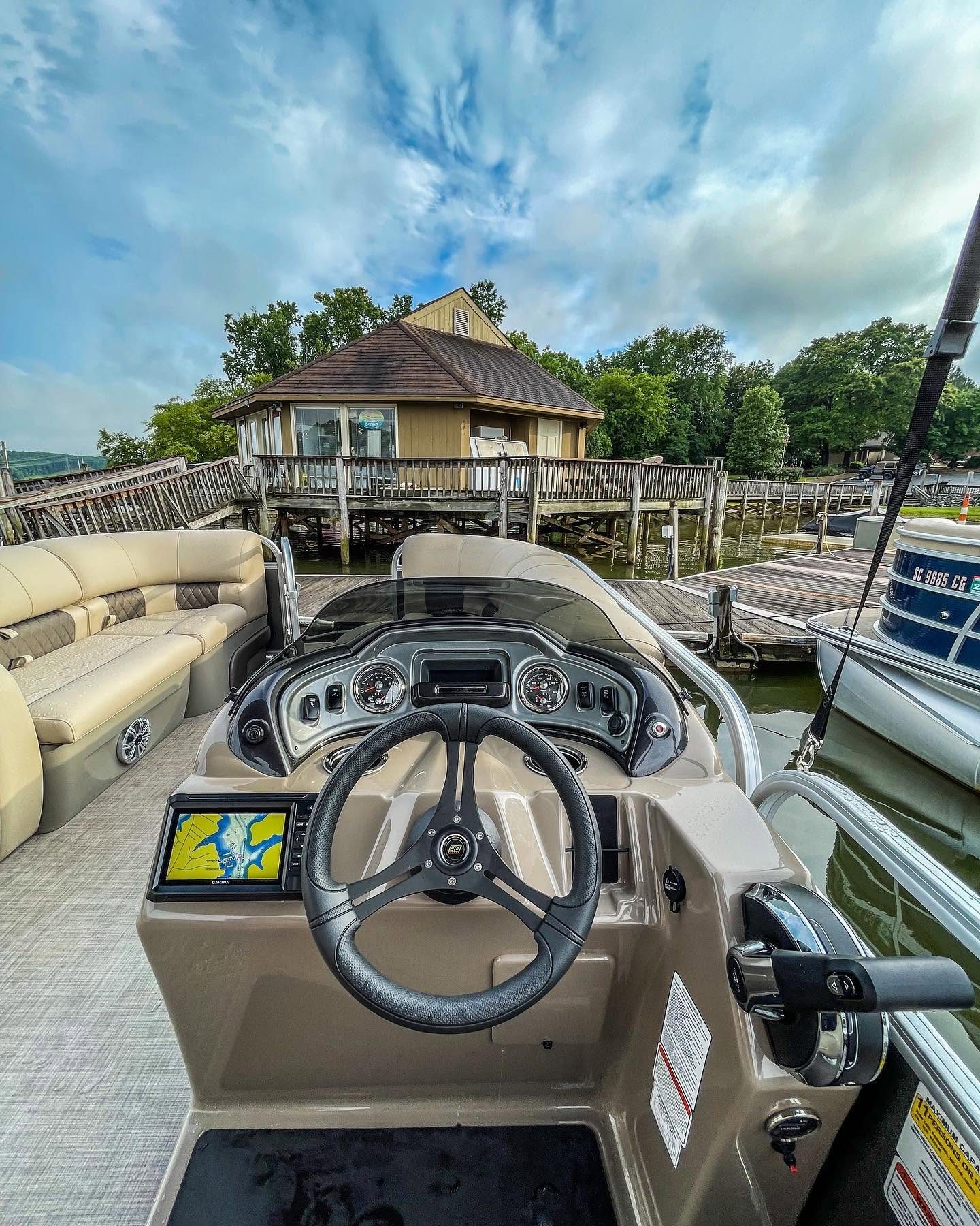 Helm and Garmin chartplotter of the pontoon at the dock